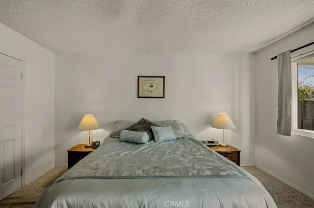 a bedroom with bed and window