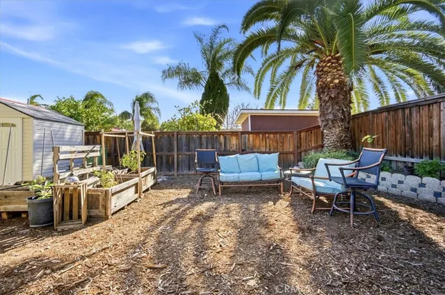 a view of a backyard with furniture and a fire pit