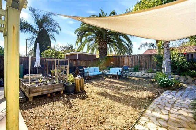 a view of a house with swimming pool and sitting area