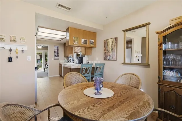 a dining room with furniture and wooden floor