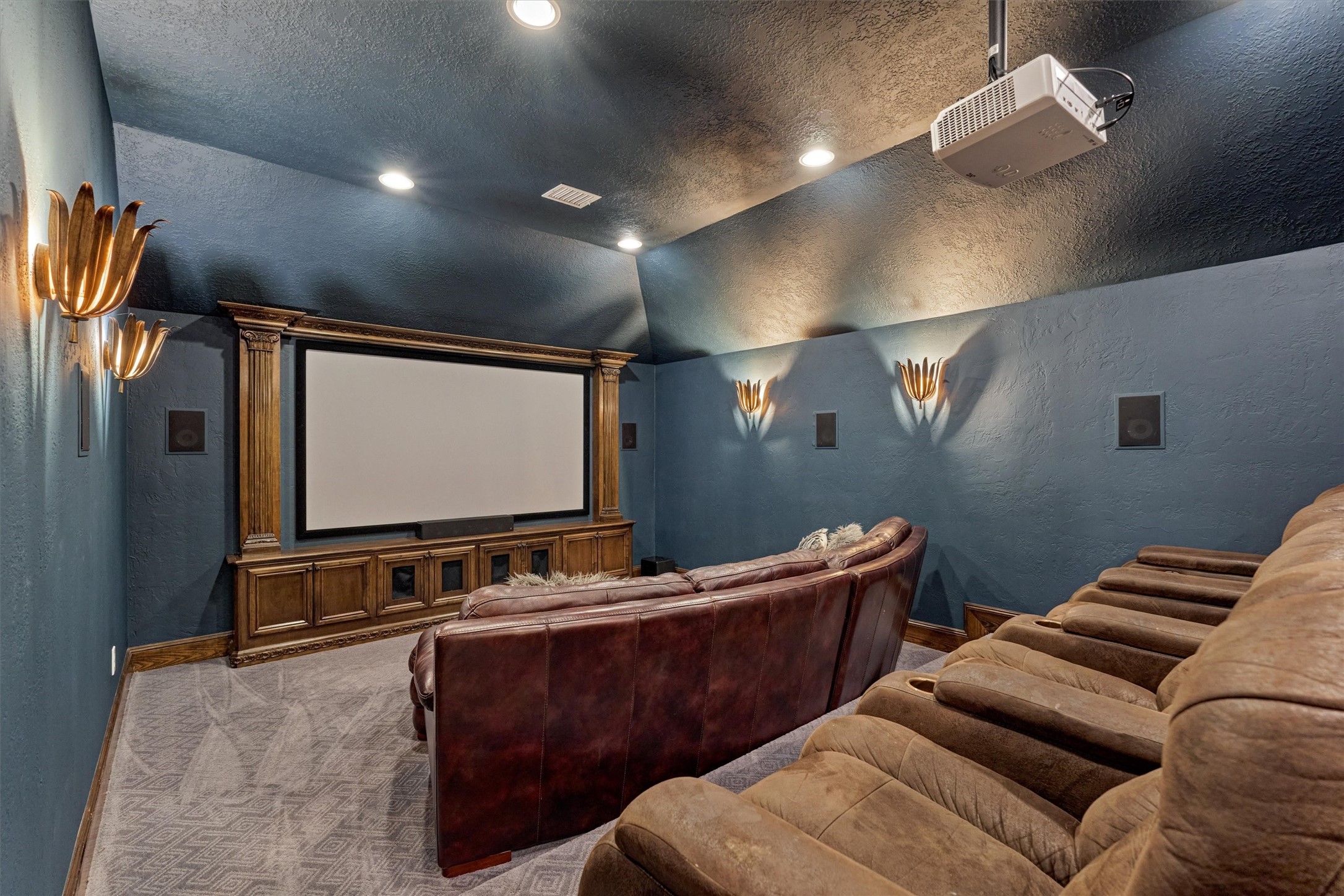 18 Treevine Court The Woodlands, TX 77381 - Photo 29 of 50 The theater-style media room is fully equipped with a projector and screen, creating a perfect space for movie nights and entertaining just off the game room.