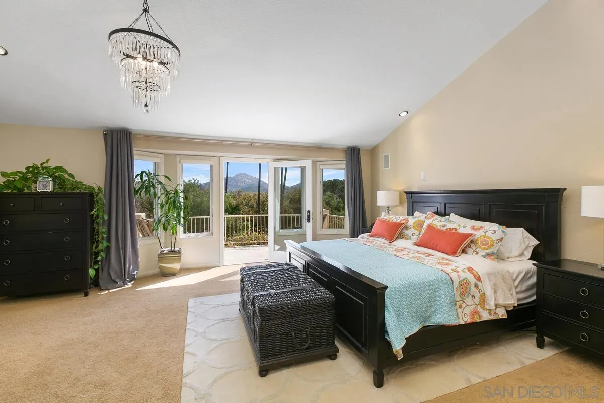 15629 Boulder Mountain Road Poway, CA 92064 - Photo 20 of 64 a bedroom with a large bed and a large window