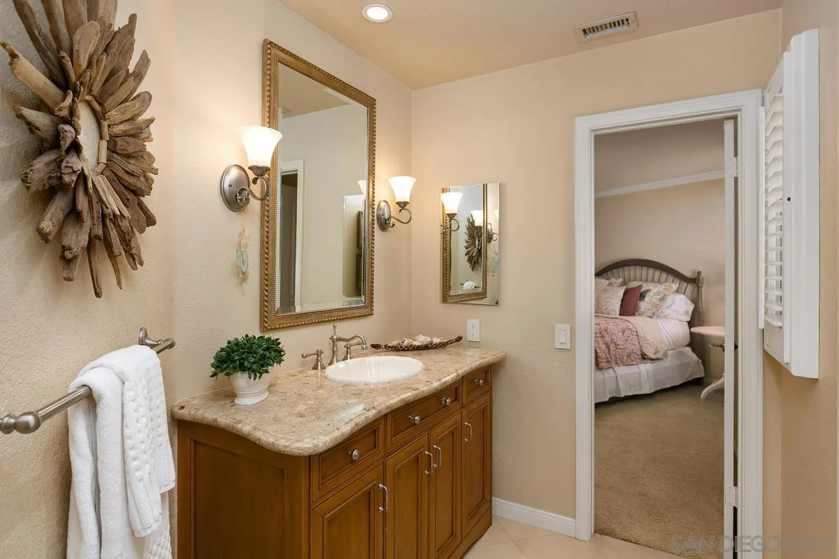15629 Boulder Mountain Road Poway, CA 92064 - Photo 26 of 64 a bathroom with a granite countertop sink and a mirror
