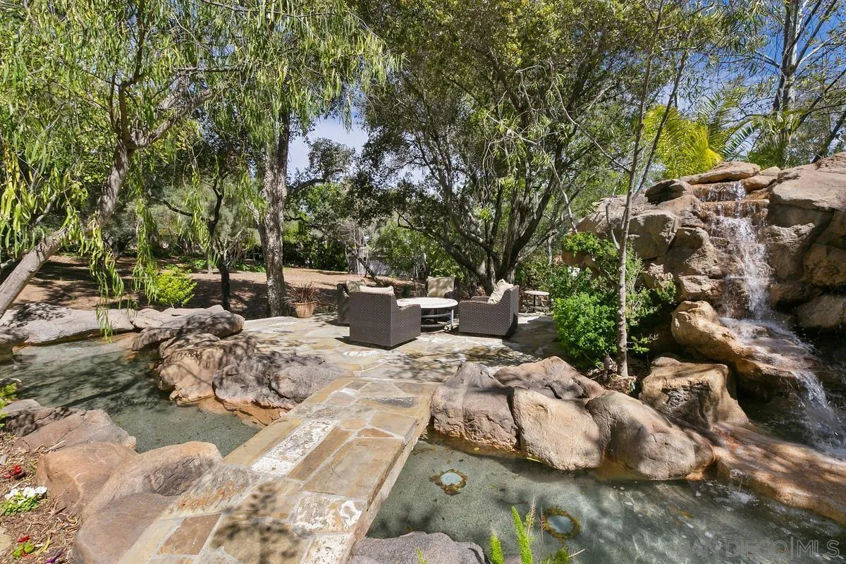 15629 Boulder Mountain Road Poway, CA 92064 - Photo 53 of 64 a view of a backyard with table and chairs and potted plants