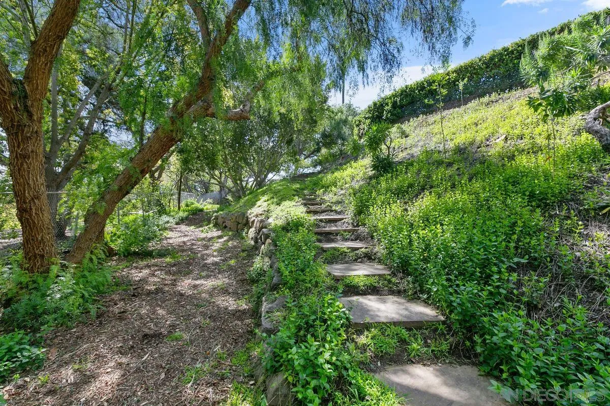 15629 Boulder Mountain Road Poway, CA 92064 - Photo 60 of 64 a view of a garden with a lawn chair and grass