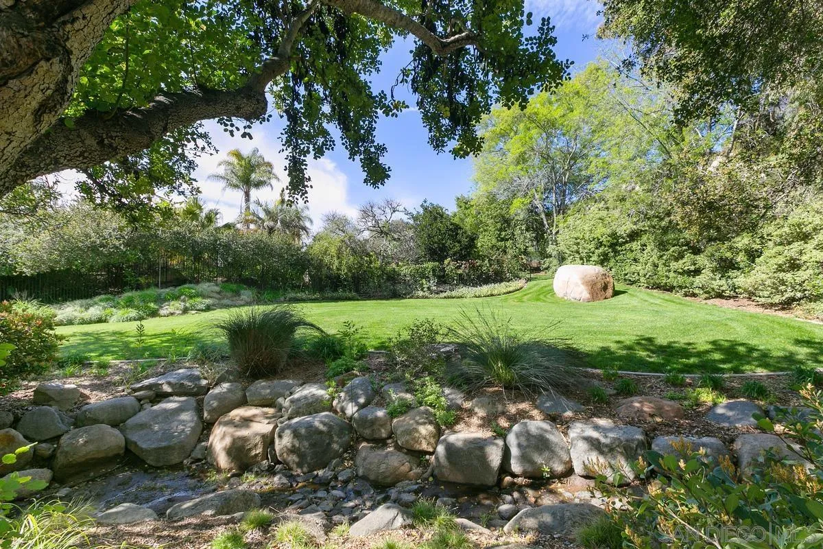 15629 Boulder Mountain Road Poway, CA 92064 - Photo 7 of 64 a view of a garden with plants and a bench