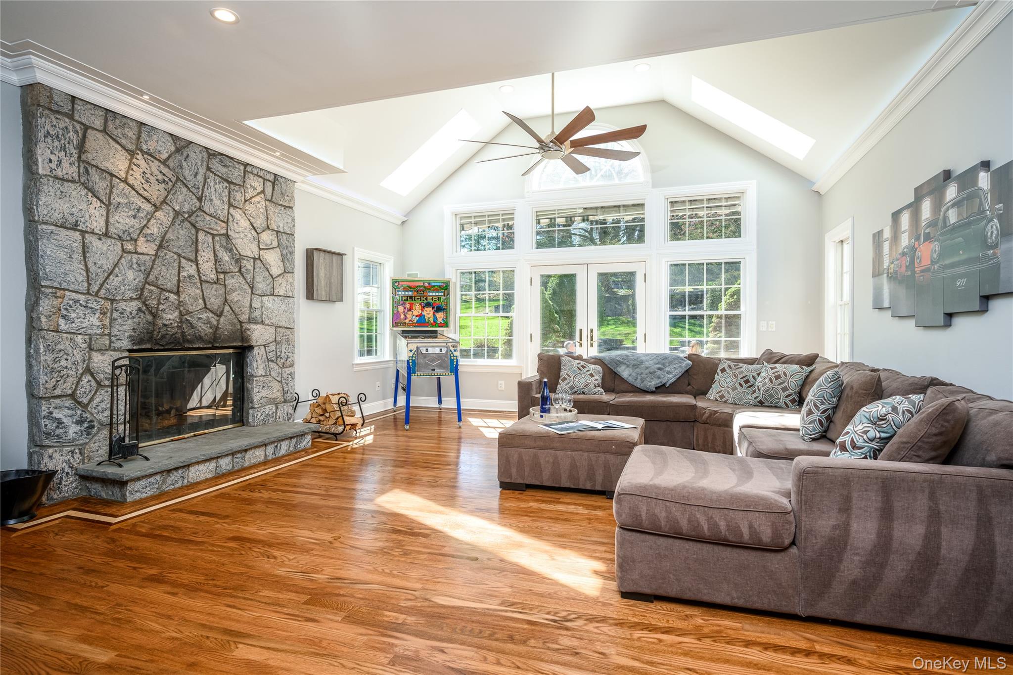 178 Hirst Road Briarcliff Manor, NY 10510 - Photo 13 of 39 Living area featuring a skylight, a high ceiling, ornamental molding, wood finished floors, and a fireplace