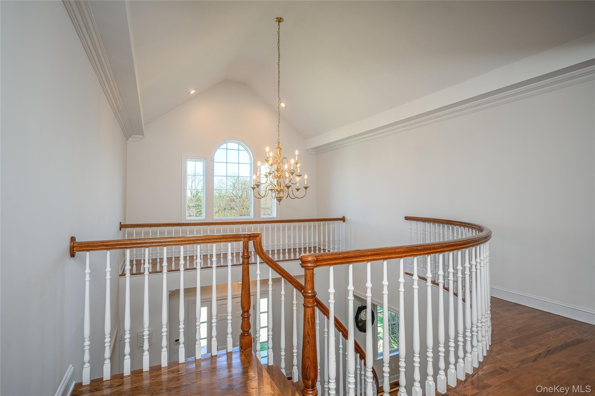 178 Hirst Road Briarcliff Manor, NY 10510 - Photo 18 of 39 Stairs featuring hanging lights, wood finished floors, and a high ceiling