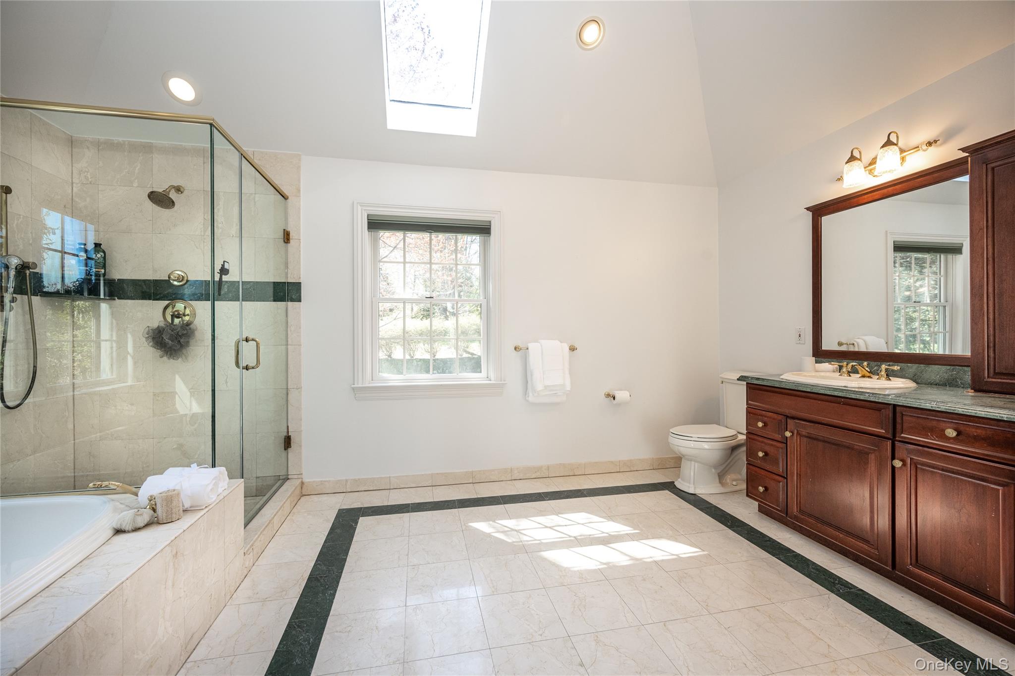 178 Hirst Road Briarcliff Manor, NY 10510 - Photo 22 of 39 Full bathroom with a skylight, inlaid floor details, vanity, a stall shower, and a bath