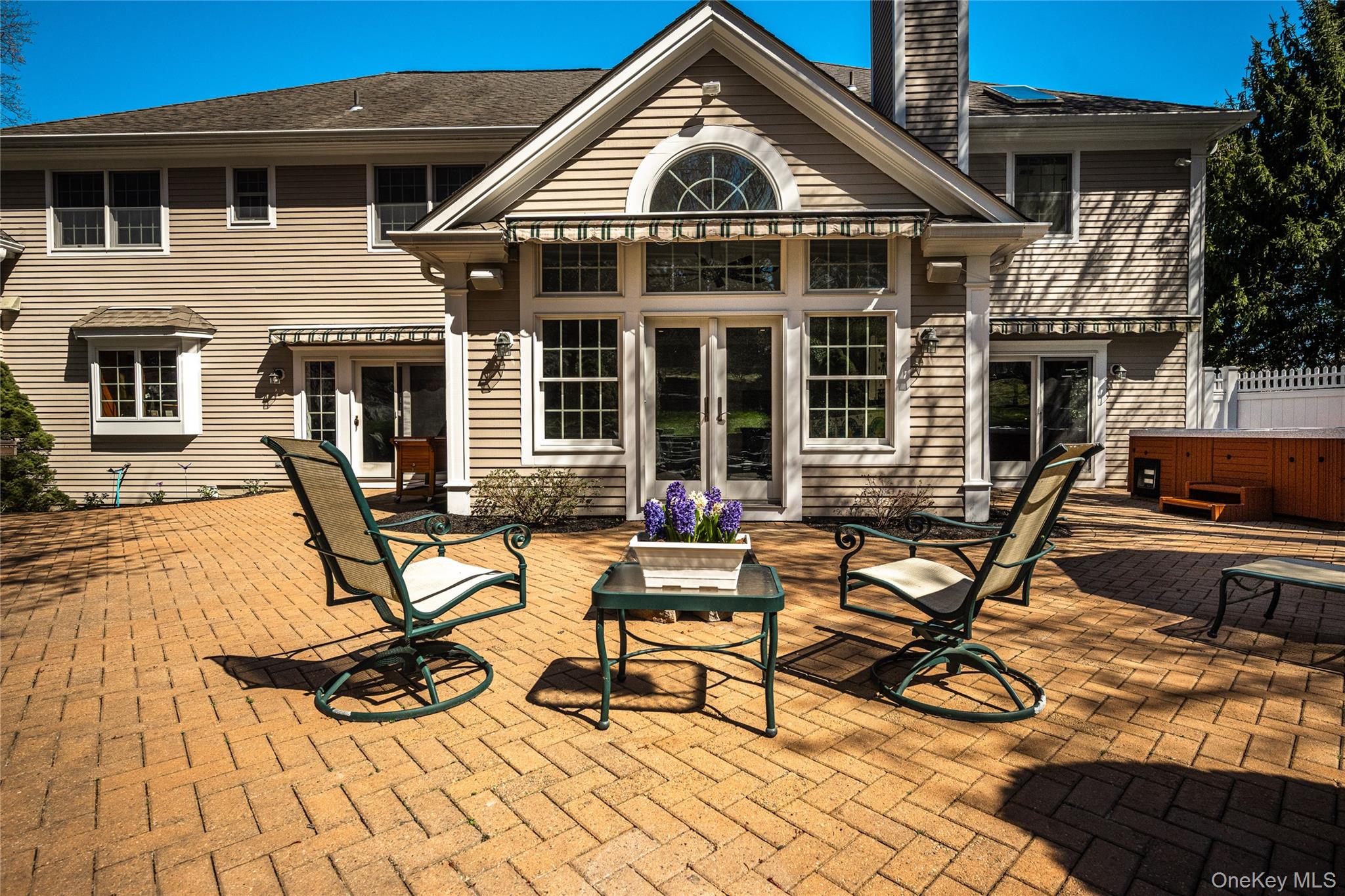 178 Hirst Road Briarcliff Manor, NY 10510 - Photo 31 of 39 Back of property featuring french doors, a hot tub, a chimney, and a patio