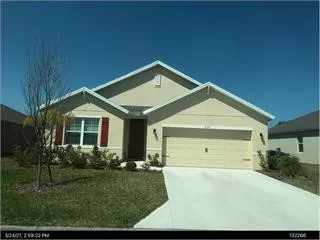 a view of a house with a yard and garage