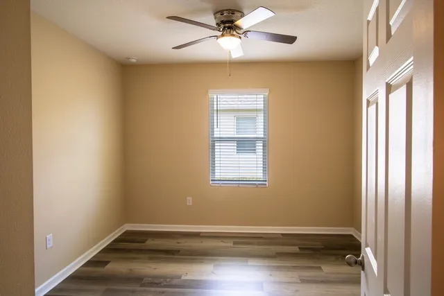 a view of room with window and ceiling fan