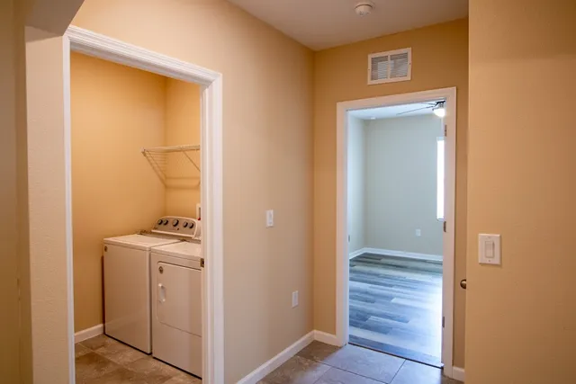 a view of bathroom with a sink mirror and window