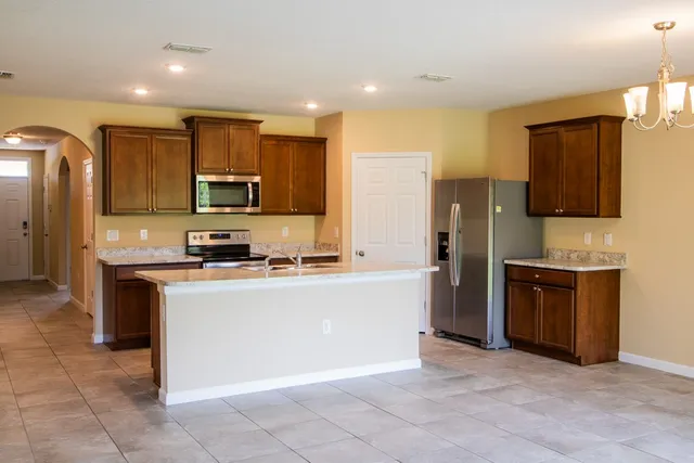 a kitchen with stainless steel appliances granite countertop a refrigerator stove and microwave