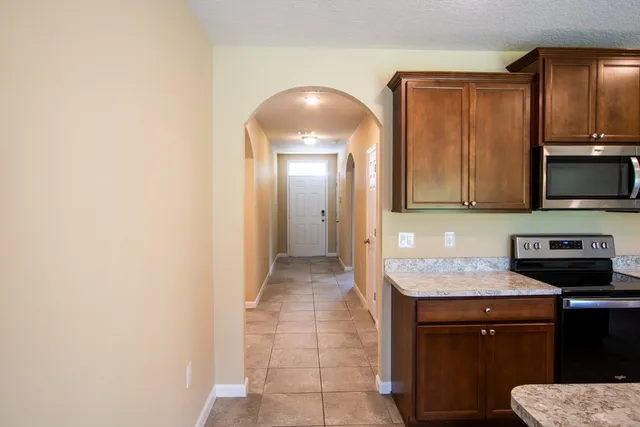 a kitchen with a sink and a stove top oven