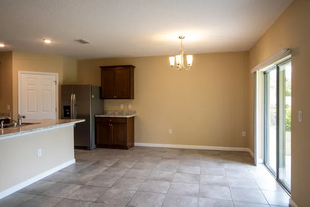 a large kitchen with a large counter top space appliances and cabinets