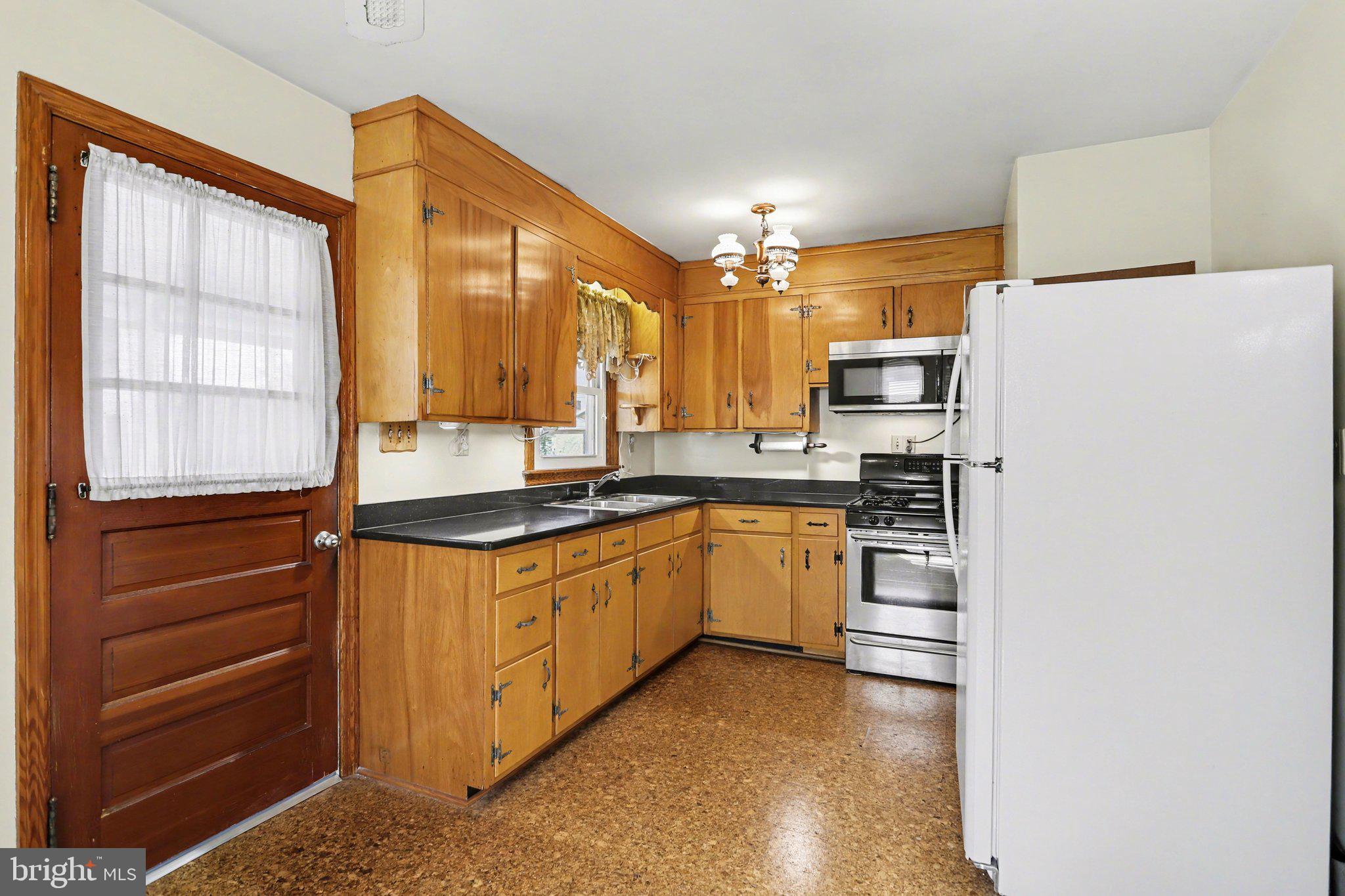 932 East Walnut Street Hanover, PA 17331 - Photo 11 of 44 a kitchen with stainless steel appliances granite countertop a refrigerator a sink and a stove