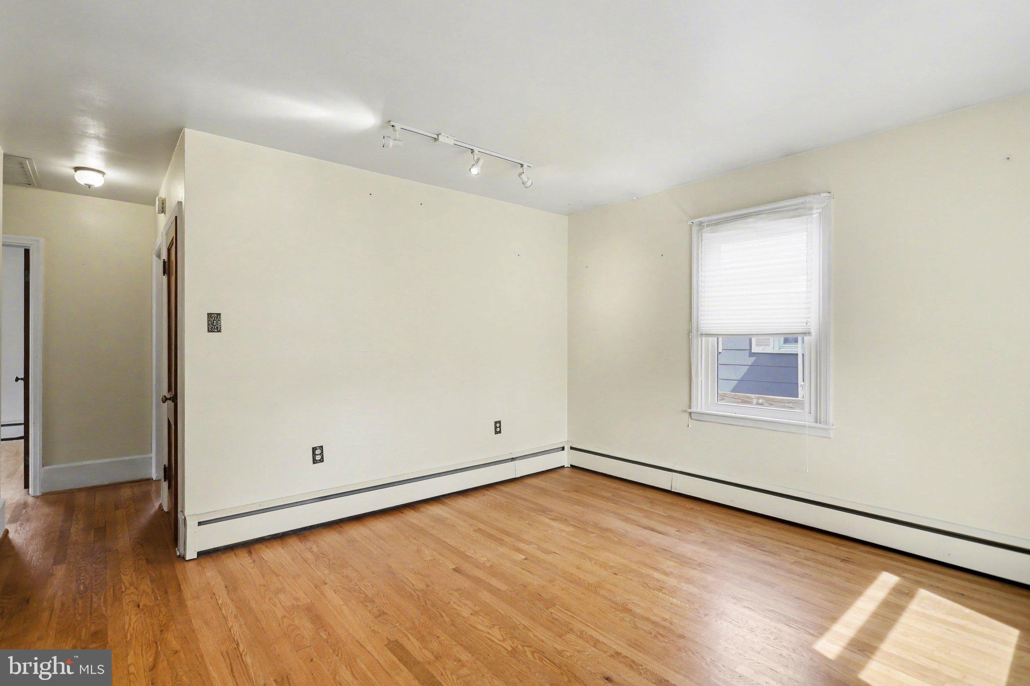 932 East Walnut Street Hanover, PA 17331 - Photo 14 of 44 an empty room with wooden floor and windows