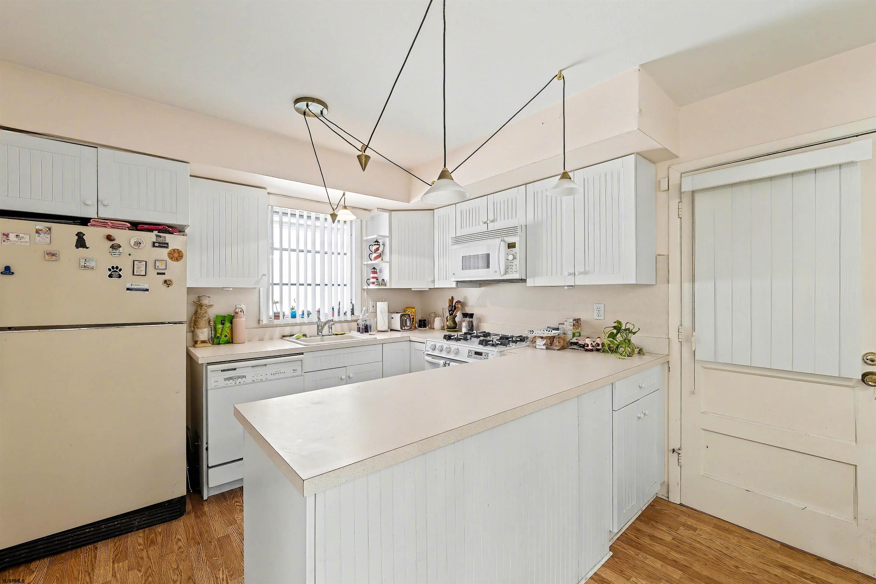 116 Haddon Road Somers Point, NJ 08244 - Photo 10 of 21 a kitchen with refrigerator and white cabinets