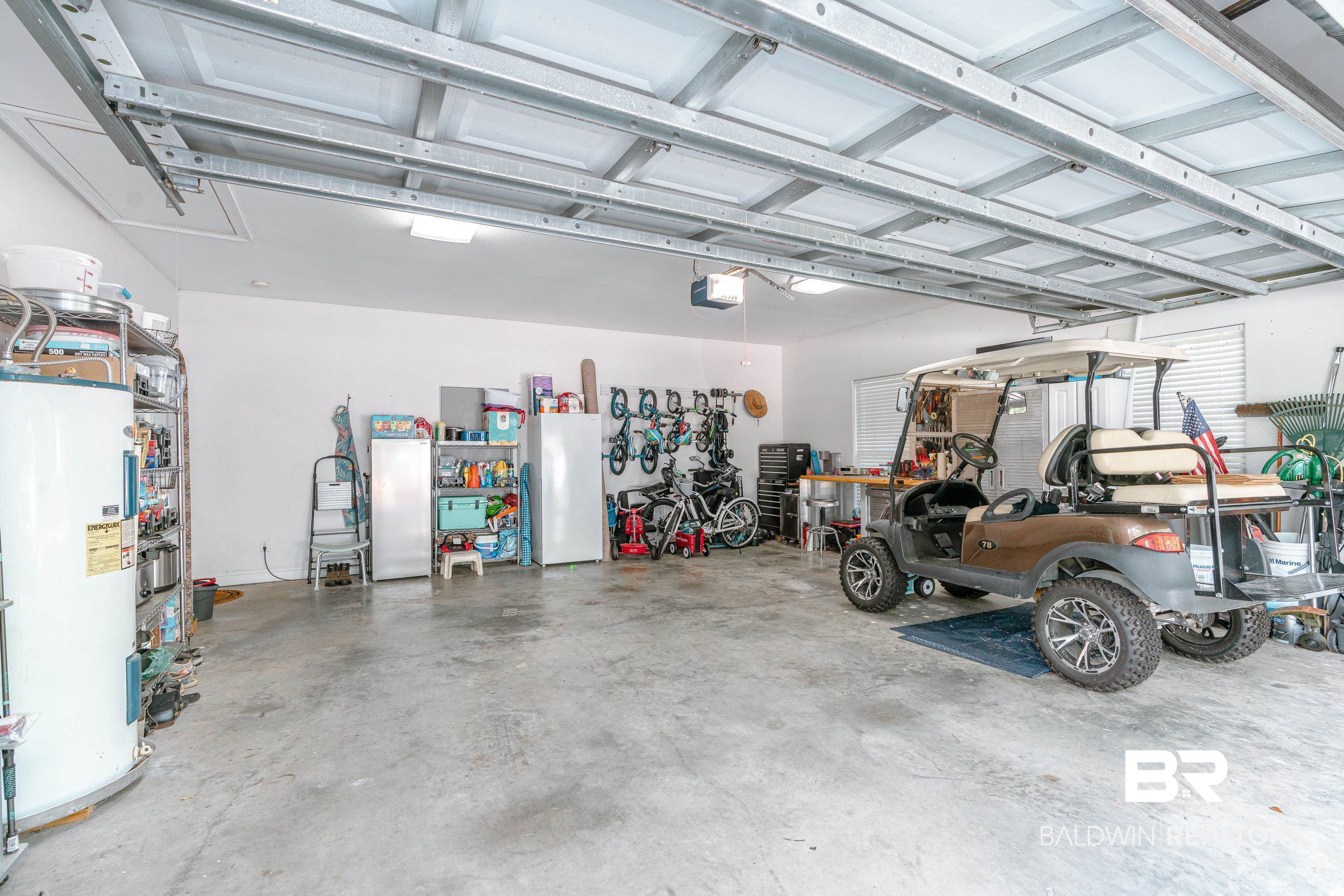 302 Bristol Way Foley, AL 36535 - Photo 27 of 51 Garage with a garage door opener, water heater, and white refrigerator