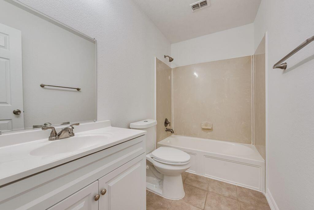 2640 Lake Ridge Drive Little Elm, TX 75068 - Photo 11 of 15 a bathroom with a sink a toilet and shower