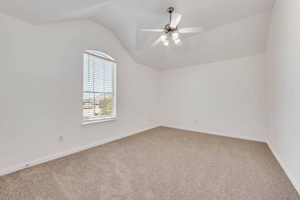 2640 Lake Ridge Drive Little Elm, TX 75068 - Photo 12 of 15 an empty room with windows and chandelier fan