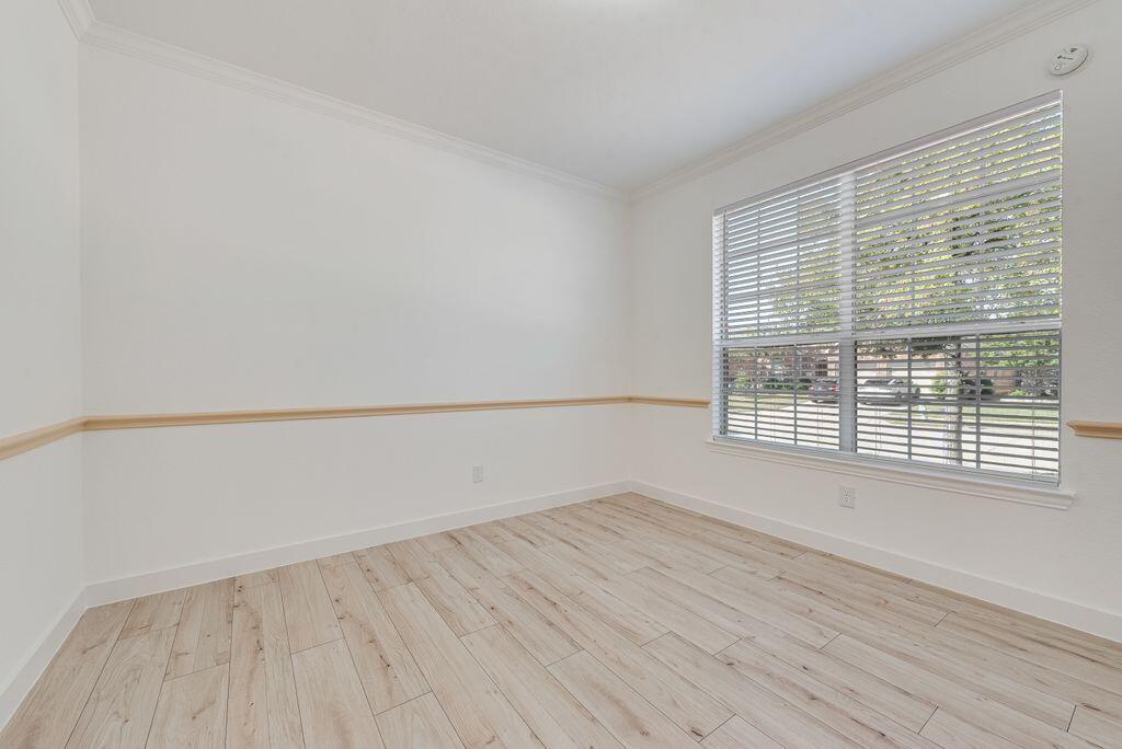 2640 Lake Ridge Drive Little Elm, TX 75068 - Photo 2 of 15 a view of an empty room with wooden floor and a window