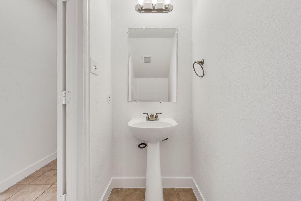 2640 Lake Ridge Drive Little Elm, TX 75068 - Photo 7 of 15 a bathroom with a sink and a mirror