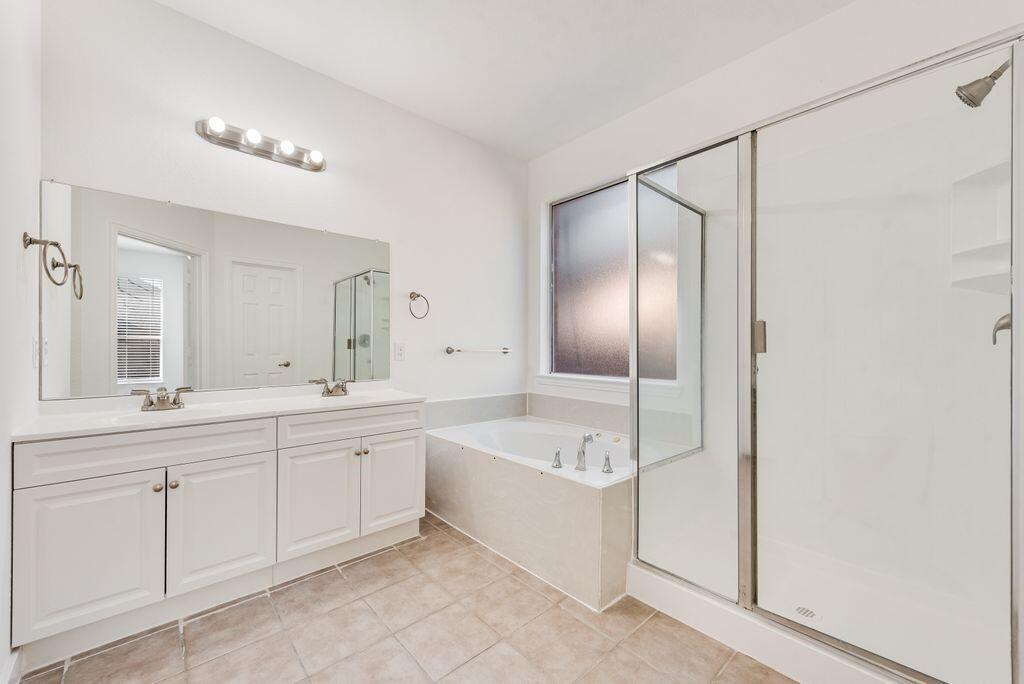 2640 Lake Ridge Drive Little Elm, TX 75068 - Photo 9 of 15 a spacious bathroom with a bathtub sink and mirror