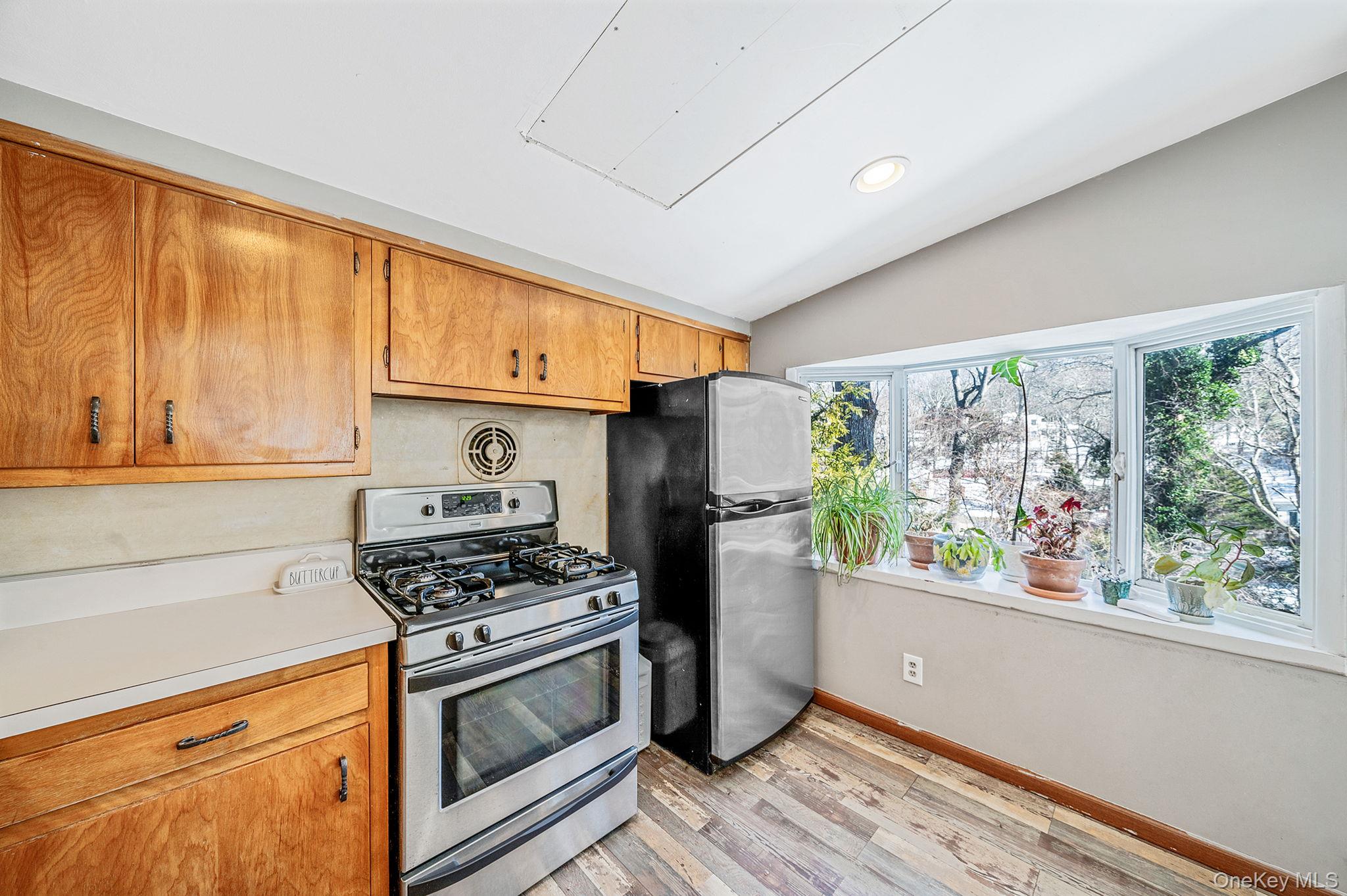 15 Ridge Lane Miller Place, NY 11764 - Photo 11 of 26 a kitchen with stainless steel appliances a stove a refrigerator and a window