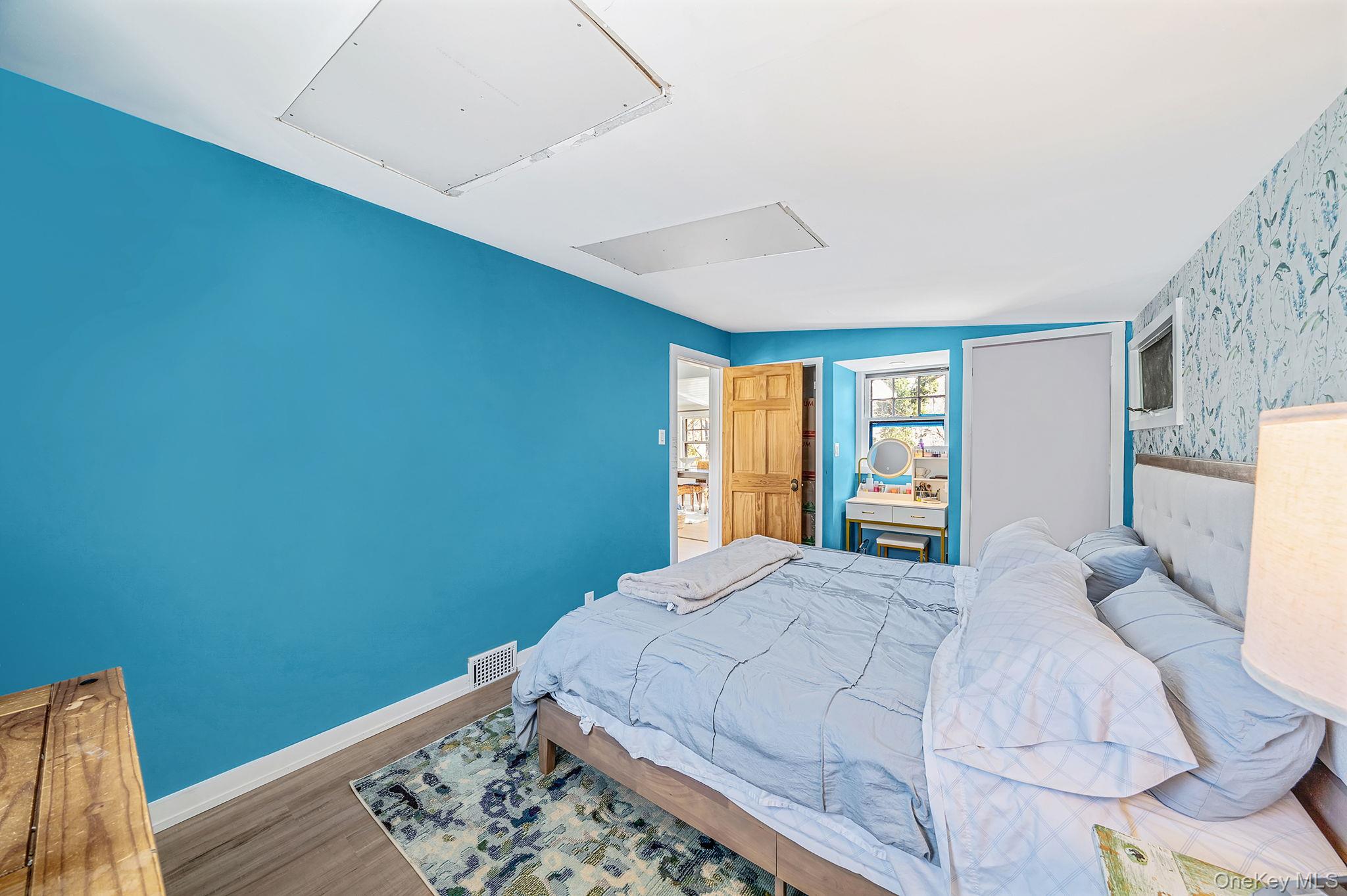 15 Ridge Lane Miller Place, NY 11764 - Photo 14 of 26 a bedroom with a bed and wooden floor