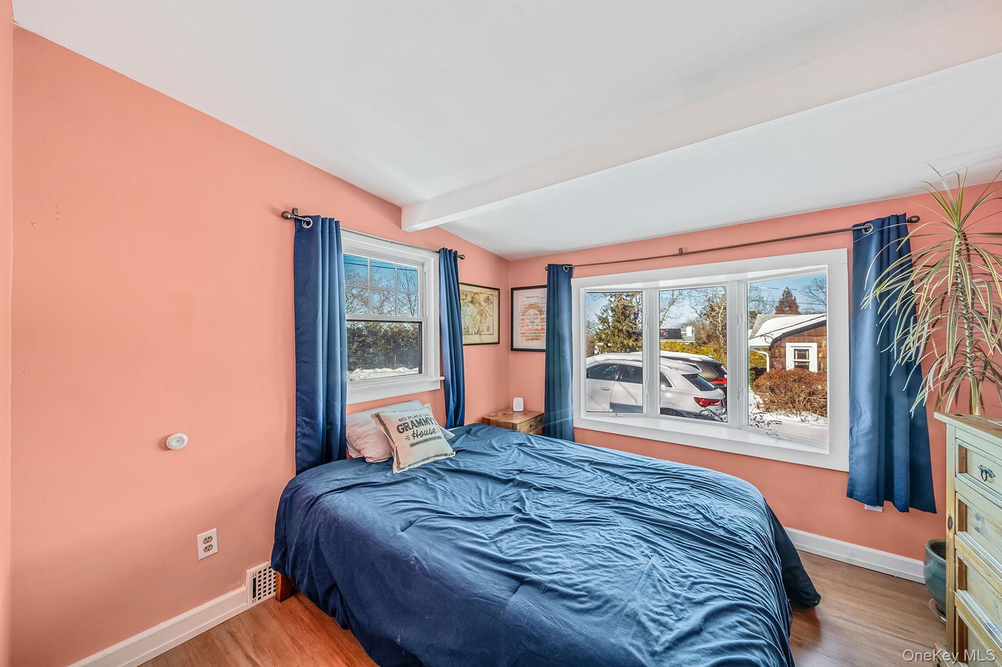 15 Ridge Lane Miller Place, NY 11764 - Photo 15 of 26 a large bed sitting in a bedroom next to a window