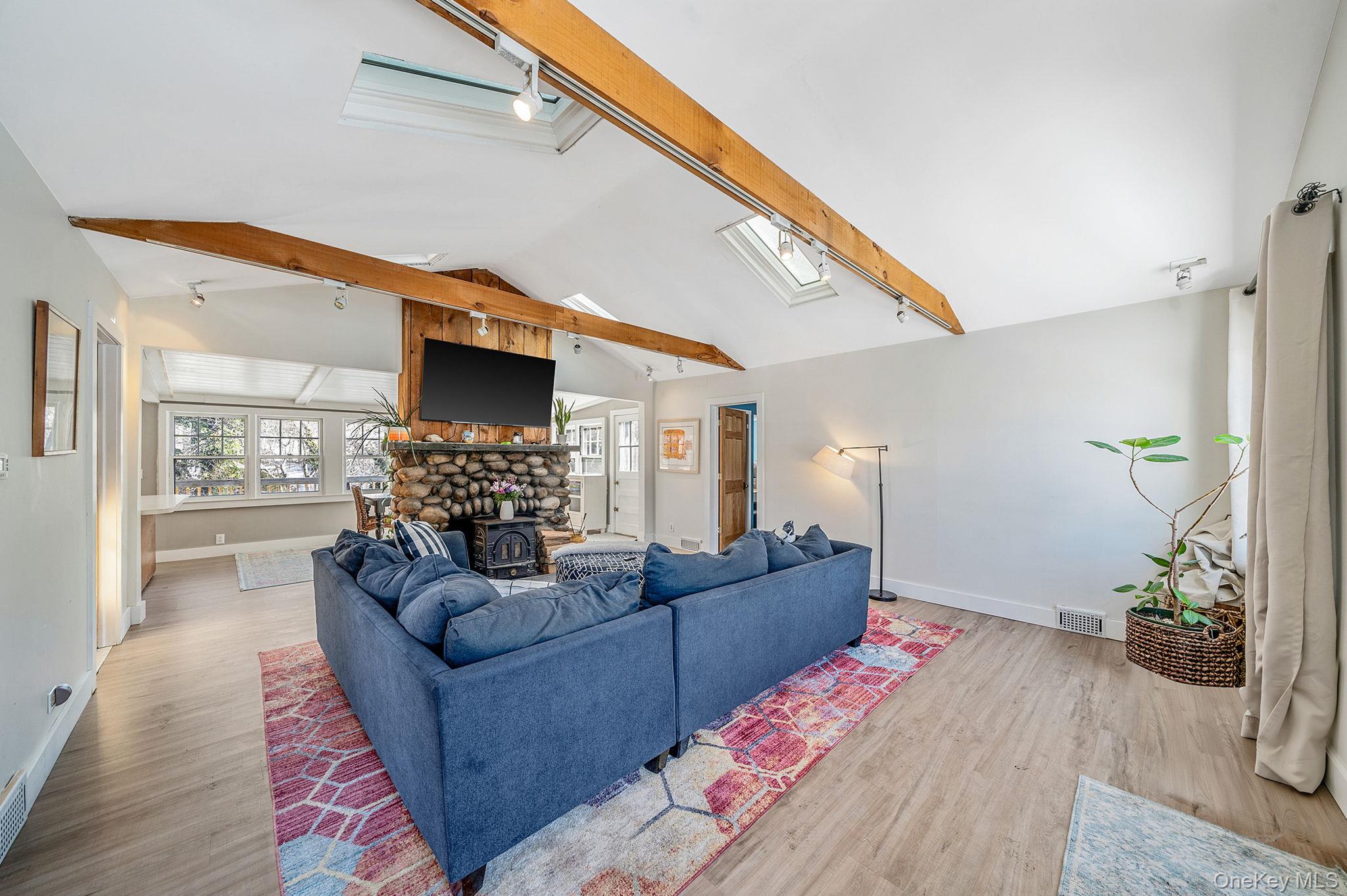 15 Ridge Lane Miller Place, NY 11764 - Photo 5 of 26 a living room with furniture and a flat screen tv