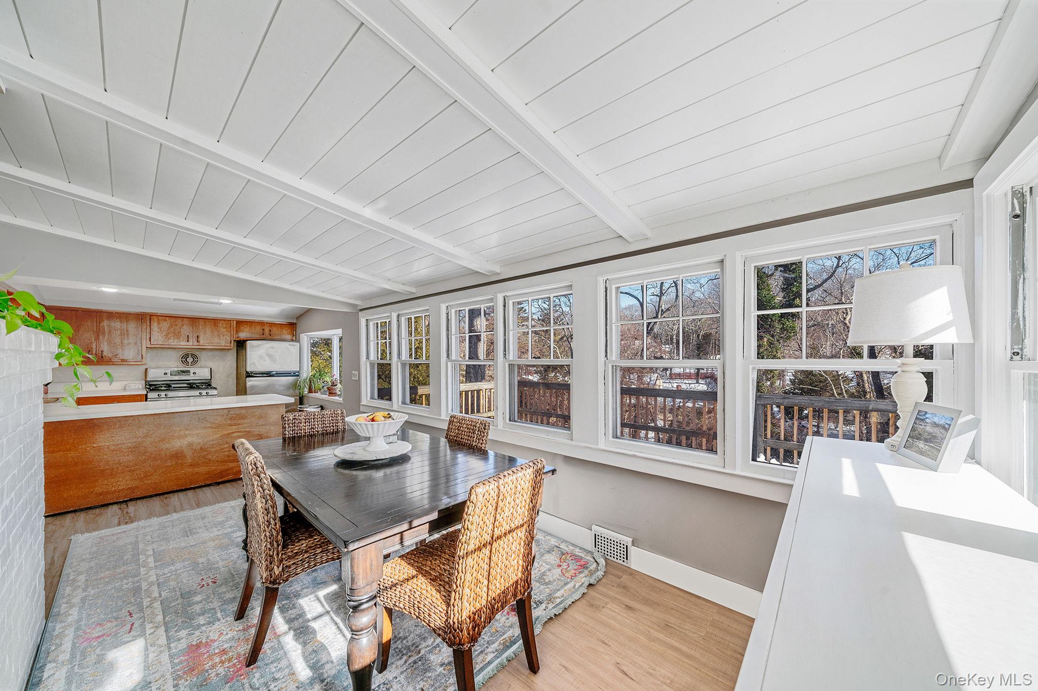 15 Ridge Lane Miller Place, NY 11764 - Photo 7 of 26 a dining room with furniture and a floor to ceiling window
