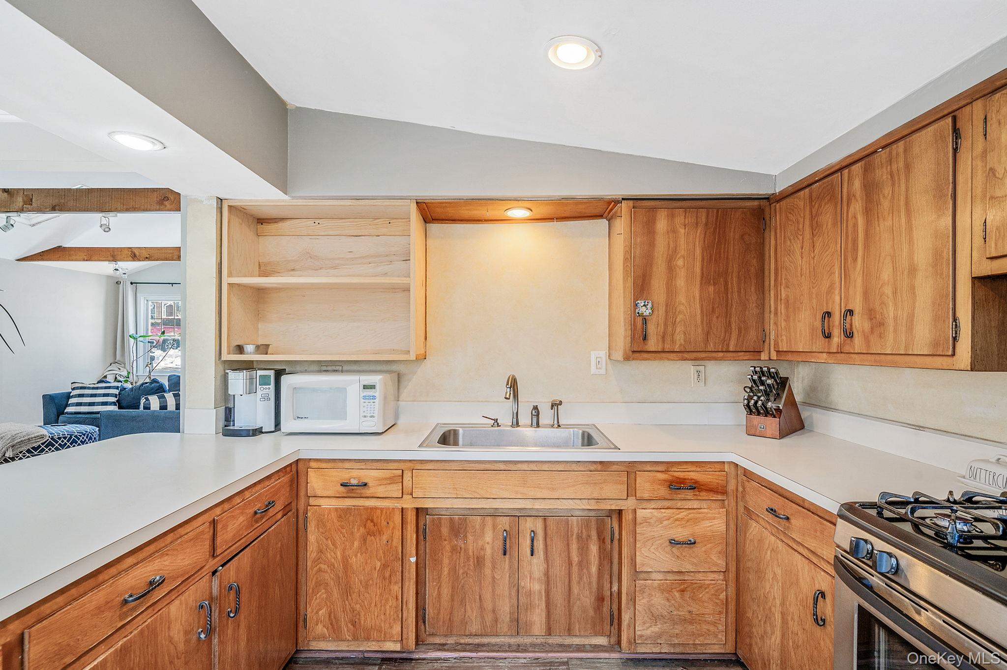 15 Ridge Lane Miller Place, NY 11764 - Photo 10 of 26 a kitchen with stainless steel appliances a sink cabinets and a window