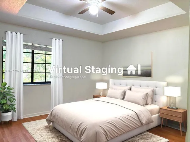 a bedroom with a large bed and a potted plant