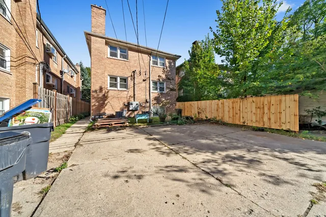 a view of a street with wooden fence