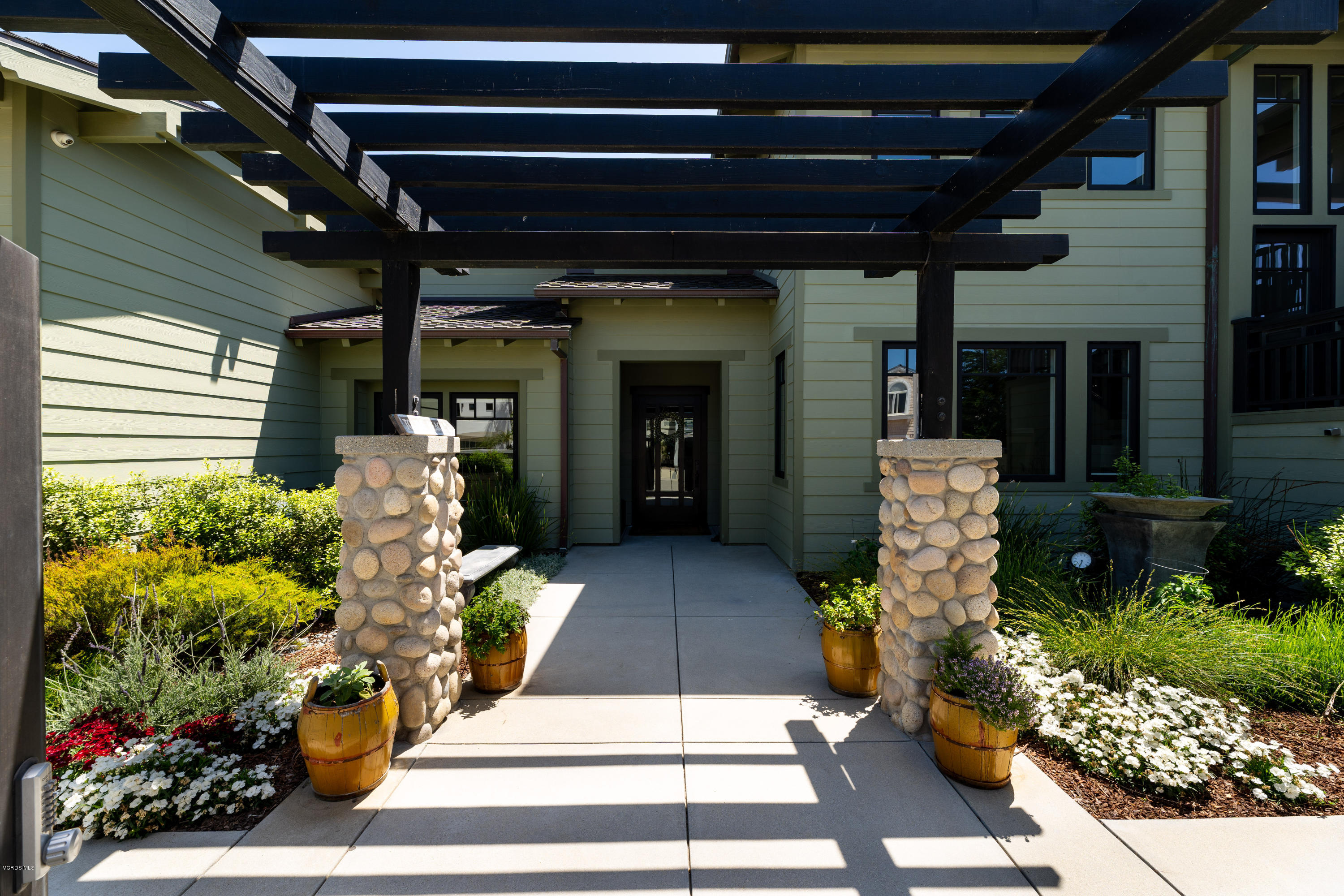 1520 Mandalay Beach Road Oxnard, CA 93035 - Photo 3 of 43 a view of a porch with dining table and chairs with potted plants