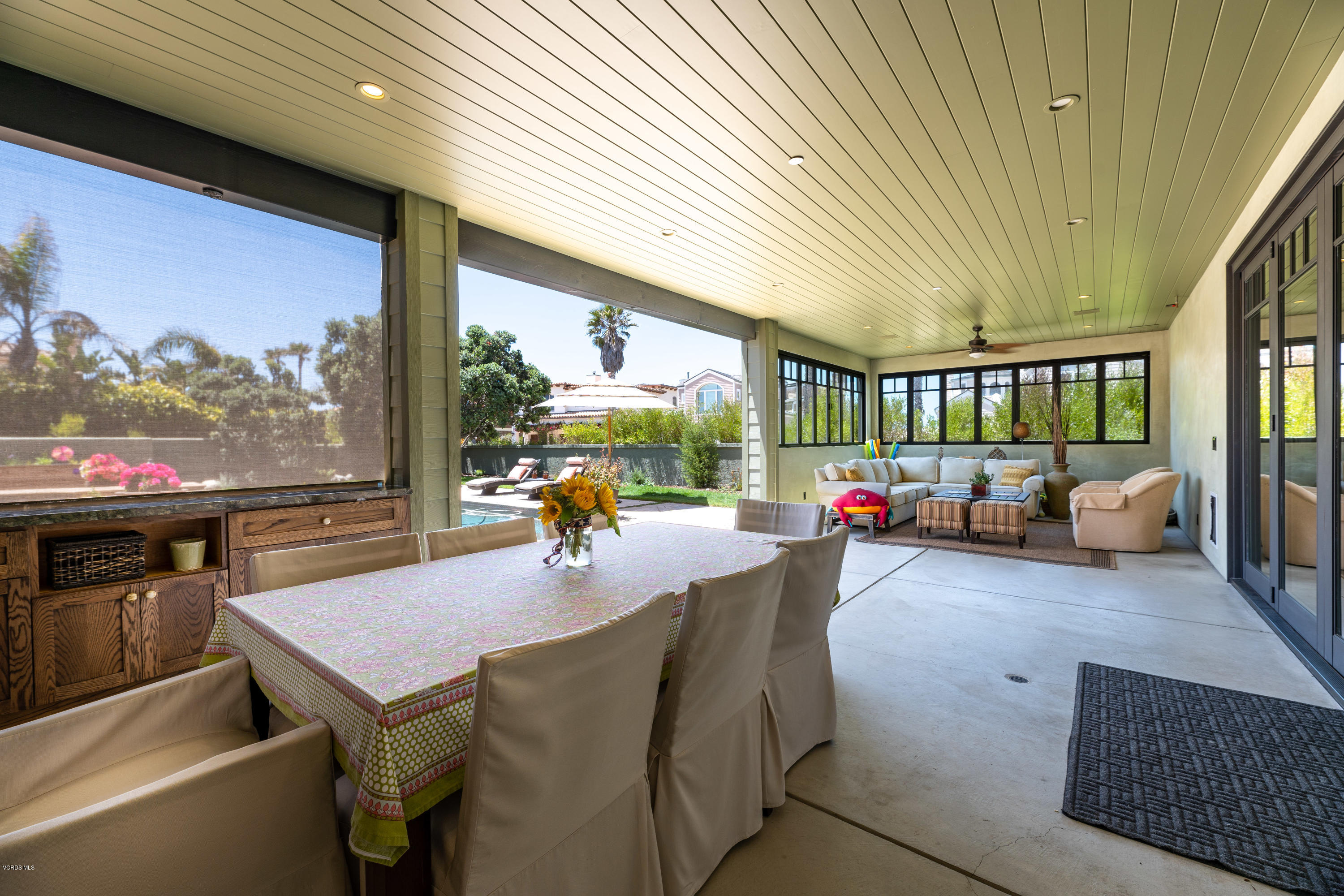 1520 Mandalay Beach Road Oxnard, CA 93035 - Photo 27 of 43 a living room with furniture a flat screen tv and a floor to ceiling window
