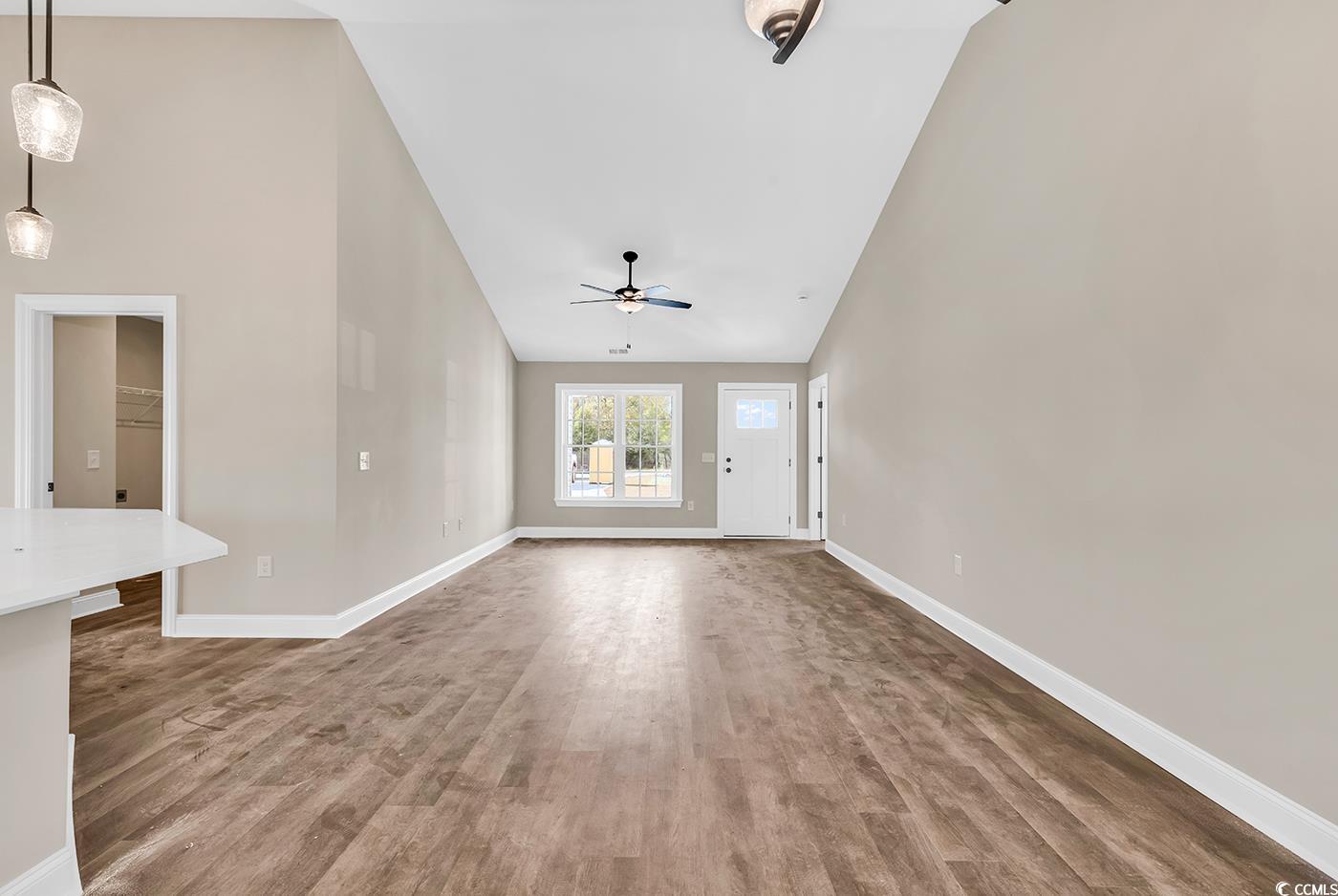 3261 Red Bluff Road Loris, SC 29569 - Photo 11 of 39 Unfurnished living room featuring light wood-style floors, high vaulted ceiling, and ceiling fan