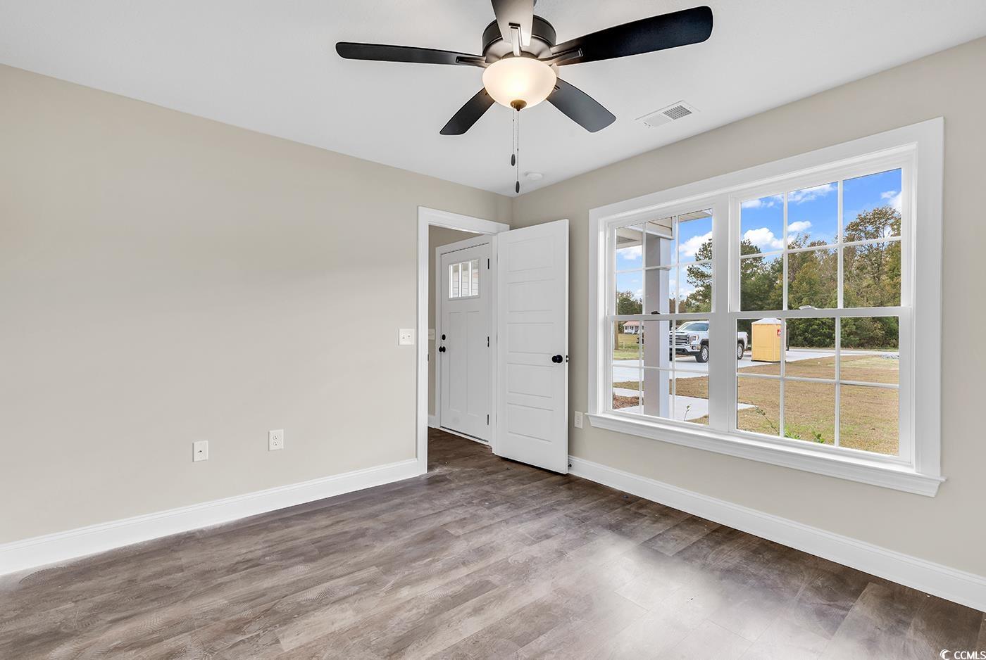 3261 Red Bluff Road Loris, SC 29569 - Photo 19 of 39 Spare room with wood finished floors and ceiling fan