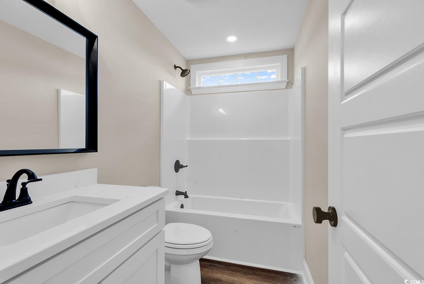 3261 Red Bluff Road Loris, SC 29569 - Photo 22 of 39 Bathroom with vanity, shower / bath combination, and dark wood-style flooring