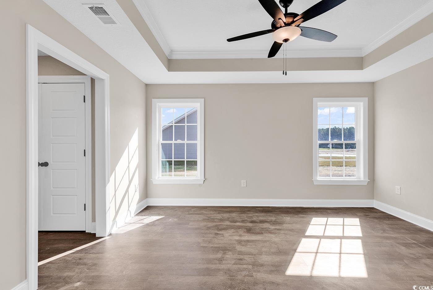 3261 Red Bluff Road Loris, SC 29569 - Photo 28 of 39 Spare room featuring a raised ceiling, ornamental molding, wood finished floors, and a ceiling fan
