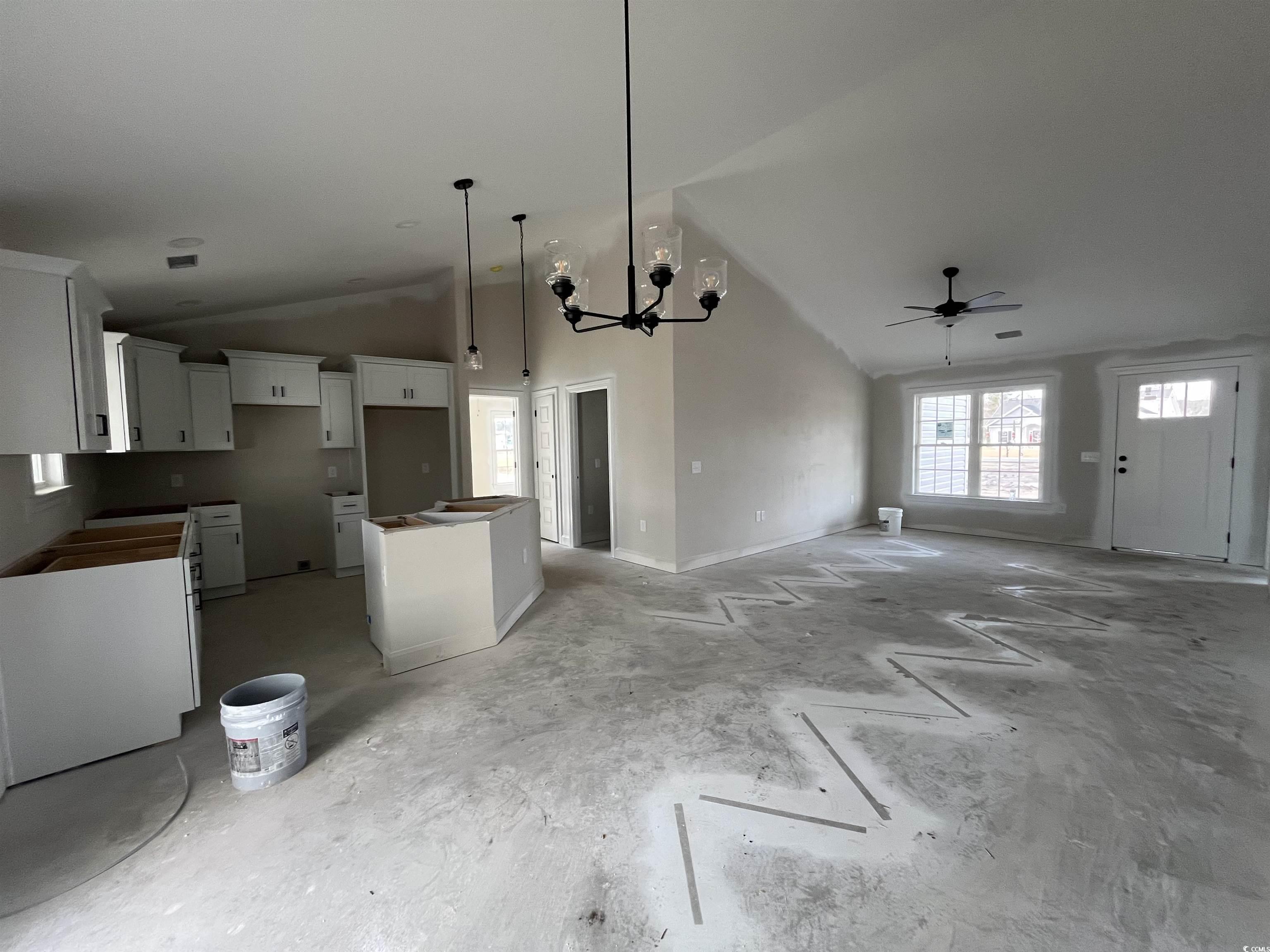 3261 Red Bluff Road Loris, SC 29569 - Photo 39 of 39 Kitchen featuring a chandelier, a kitchen island, open floor plan, white cabinetry, and high vaulted ceiling