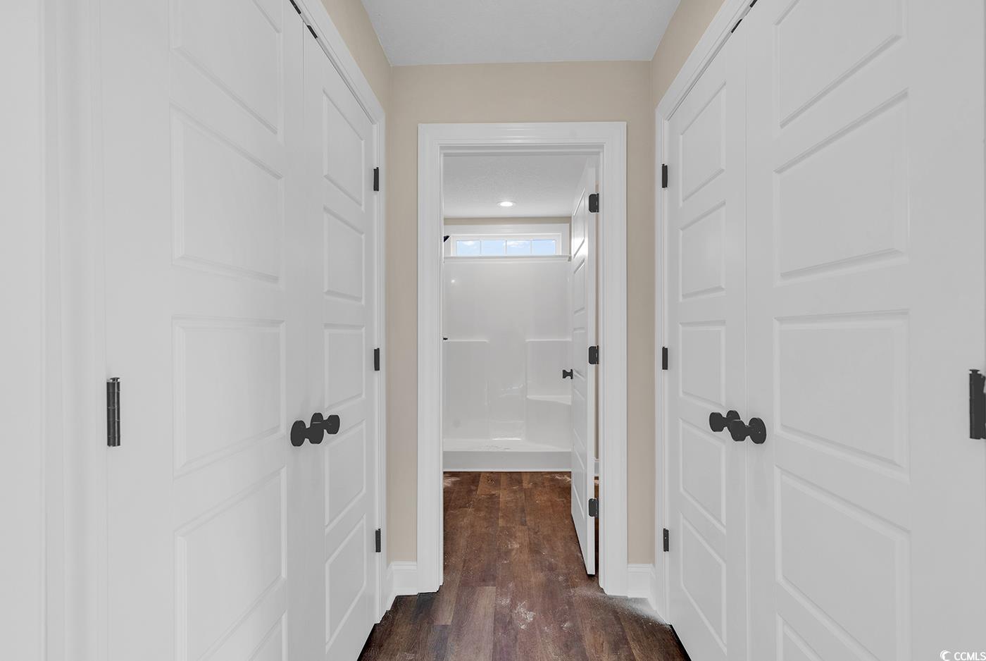 3261 Red Bluff Road Loris, SC 29569 - Photo 31 of 39 Hallway featuring dark wood-style flooring and baseboards
