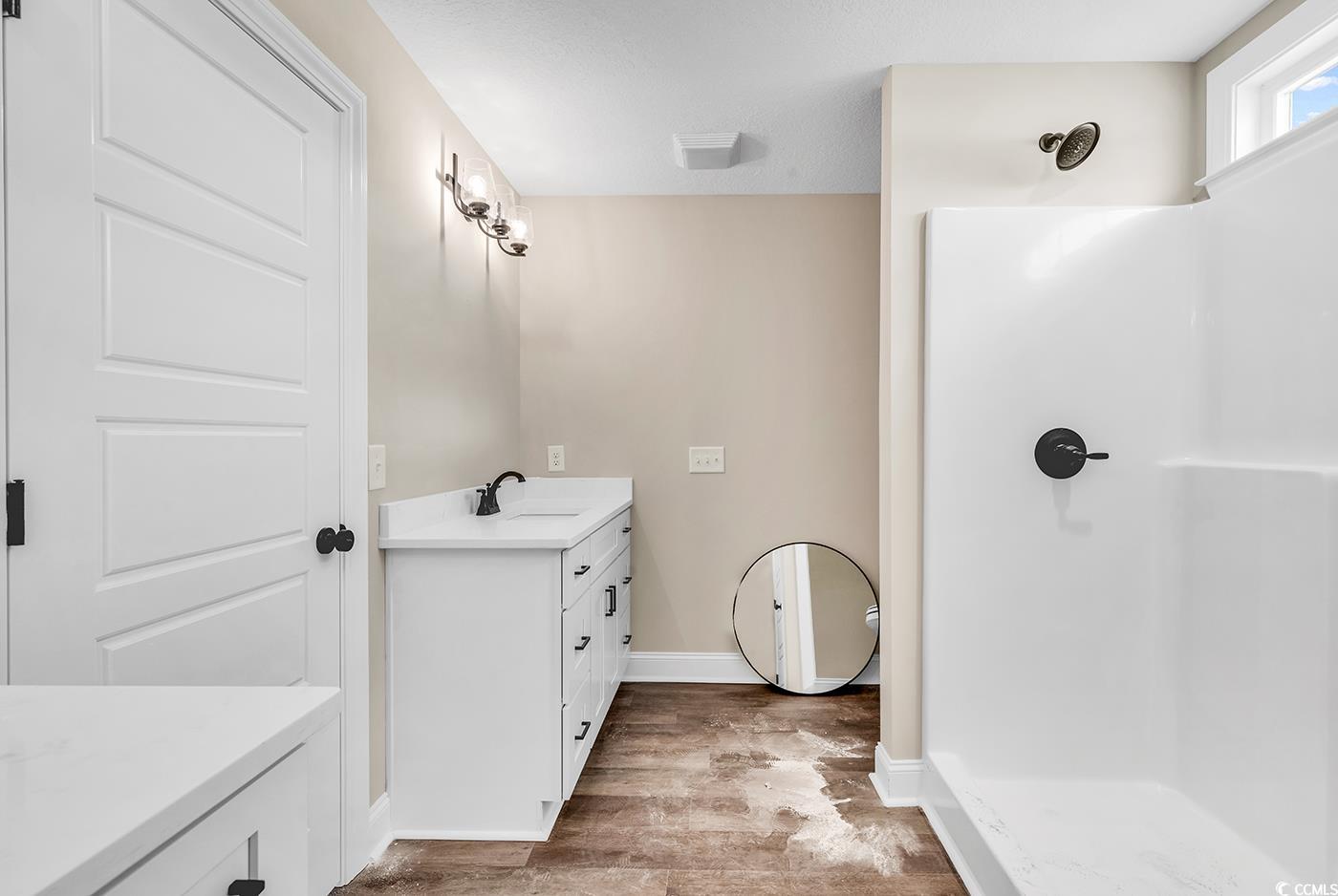 3261 Red Bluff Road Loris, SC 29569 - Photo 33 of 39 Full bathroom with vanity, a walk in shower, light wood-style floors, and a textured ceiling