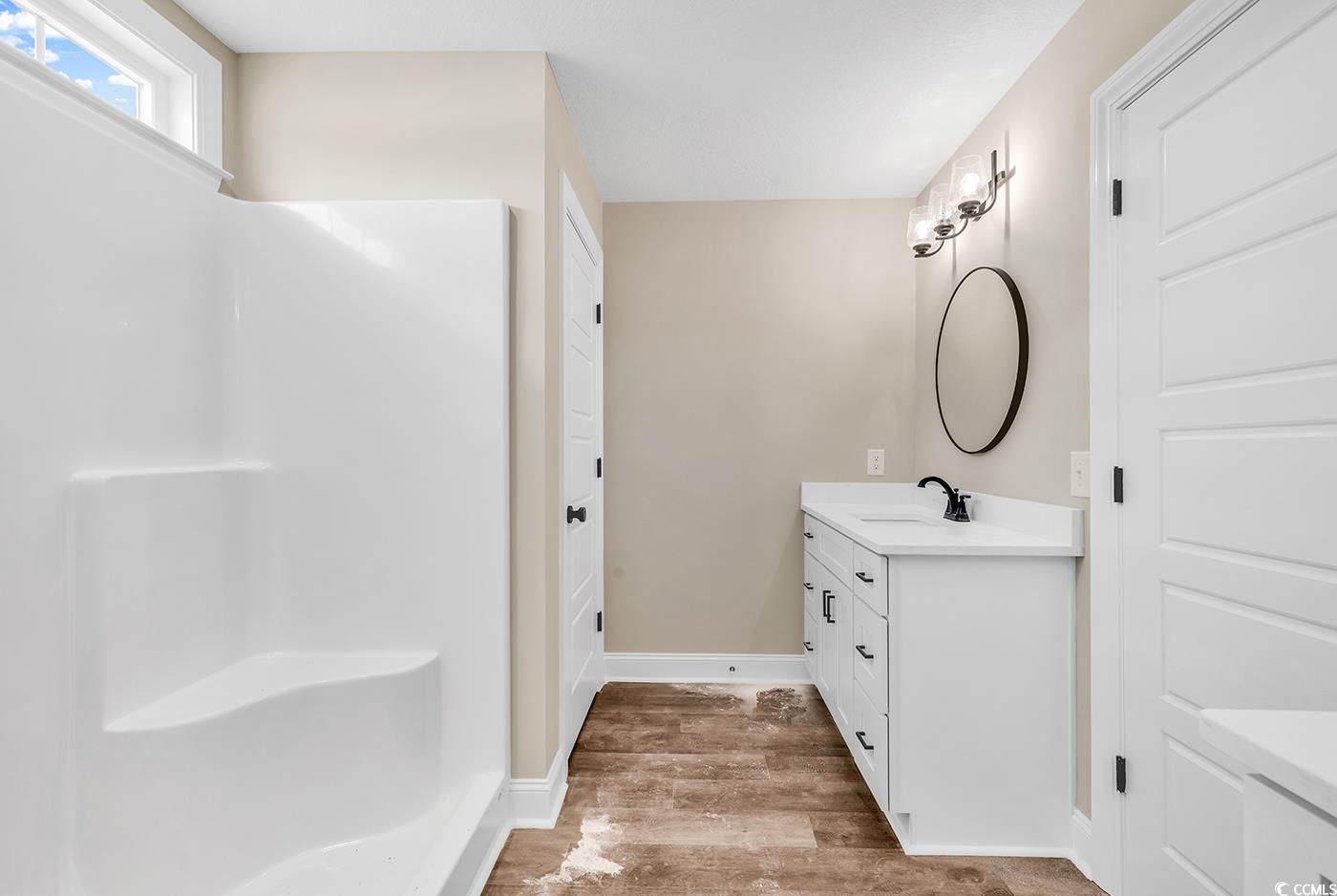 3261 Red Bluff Road Loris, SC 29569 - Photo 34 of 39 Bathroom featuring vanity, light wood-style flooring, and a shower