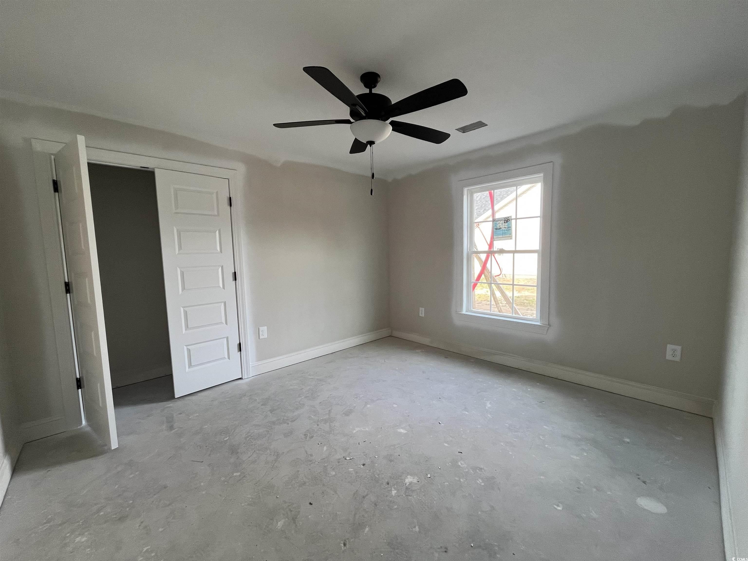 3261 Red Bluff Road Loris, SC 29569 - Photo 7 of 39 Unfurnished bedroom featuring unfinished concrete flooring, a ceiling fan, and a closet