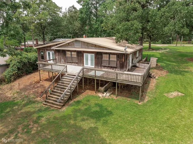 an aerial view of a house with a yard table and chairs