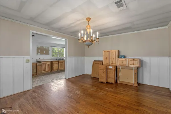 a view of a kitchen with furniture and wooden floor
